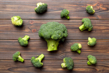green fresh broccoli background close up on colored table. Vegetables for diet and healthy eating. Organic food