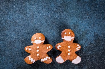 gingerbread man in face mask. Gingerbread man in medical mask. Stay home, coronavirus concept. Pandemic christmas. Cookie couple in mask. New year covid 19.