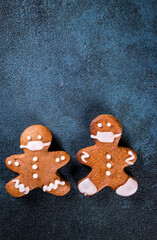 gingerbread man in face mask. Gingerbread man in medical mask. Stay home, coronavirus concept. Pandemic christmas. Cookie couple in mask. New year covid 19.