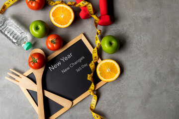 New Year for New Changes Healthy 2022.  Fresh vegetable fruits and healthy food for sport equipment for women diet slimming weight loss.  Healthy and Holiday Concept