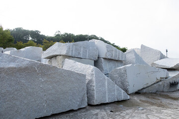 Stacks of heavy granite stones extracted from natural stone quarry.