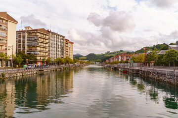 Fototapeta na wymiar Panoramic view of Narrondo river in the spanish city of Zumaia. Horizontal view of vasque city landscape with river. Travel destination in Spain.