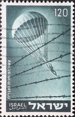 Israel circa 1955: A post stamp printed in Israel showing an an a parachutist Israeli paratroopers...