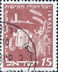 Israel circa 1951: A post stamp printed in Israel showing a Agricultural Machinery Farmer on Tractor