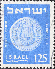 Israel circa 1954: A post stamp printed in Israel showing a coin with a lyre