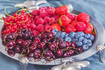 Different berries in silver dish