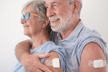 Smiling attractive 70-year-old couple after receiving third dose of covid-19 coronavirus vaccine....