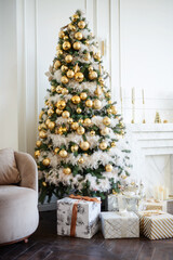 Big beautiful New Year tree with gifts in a white decorated hall for the New Year