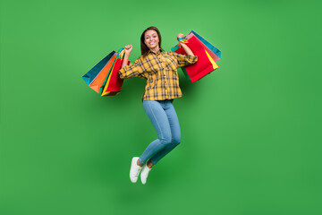 Full length photo of excited lucky attractive person raise packages have good mood isolated on...