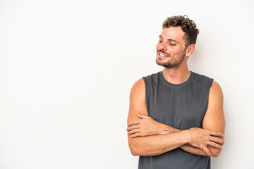 Young caucasian man isolated on white background smiling confident with crossed arms.