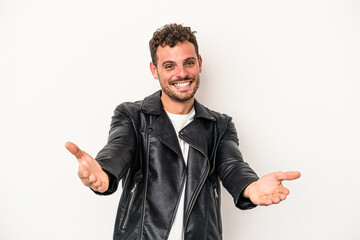 Young caucasian man isolated on white background showing a welcome expression.