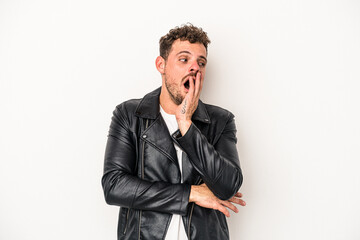 Young caucasian man isolated on white background yawning showing a tired gesture covering mouth with hand.
