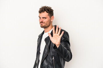 Young caucasian man isolated on white background rejecting someone showing a gesture of disgust.