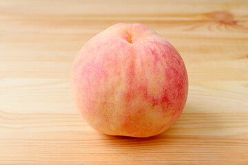 Closeup a Fresh Ripe Peach Isolated on Wooden Background