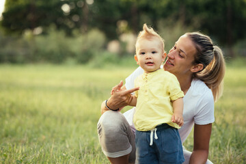 Fototapeta premium mother and her baby boy in public park