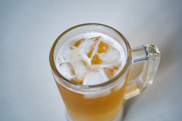 Cold beer with ice in a glass mug