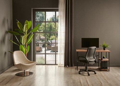 Grey living room office, monitor, chair vase of green plant in front of the window garden view.