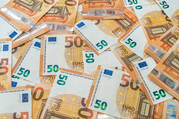 beautiful new clean 50 euro banknotes scattered on a spacious new table.