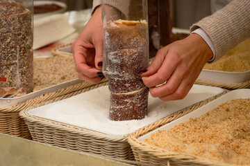 Sweet hungarian and Czech dessert - baked kurtosh kalach (Kurtoskalacs) or trdlo on the holiday street market in Serbia