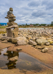 Inukshuks built by tourists at Baie Johan Beetz park, on the shore of St Lawrence river, in Cote Nord region of Quebec (Canada)