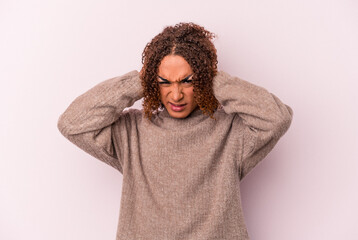 Young latin transsexual woman isolated on pink background covering ears with hands.