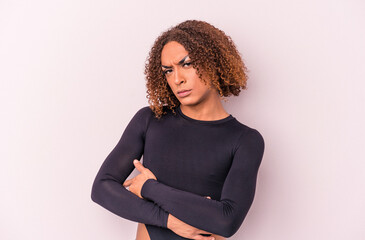 Young latin transsexual woman isolated on pink background unhappy looking in camera with sarcastic...
