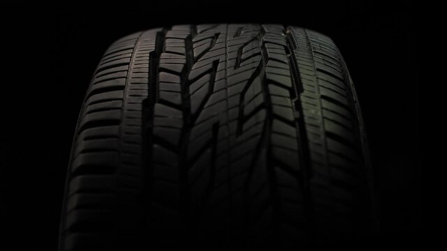 Car Tire Rotation Close-up on Black Background