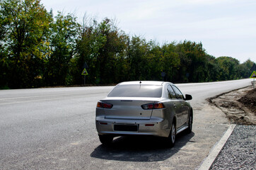 Fototapeta premium Back view of a vehicle on the asphalt road