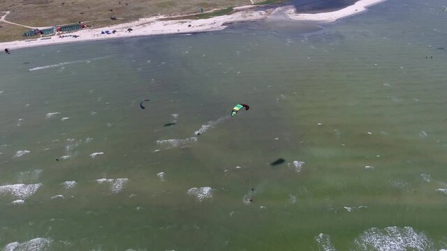 Aerial shot of two persons windsurfing at the Black Sea shore on a sunny daty