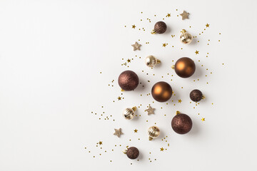 Top view photo of brown silver and golden christmas tree decorations balls shiny stars and sequins on isolated white background with empty space