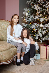 Obraz premium Portrait of happy family with Christmas gifts on floor at home