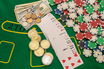 poker cards scattered with money colored chips on a green poker table