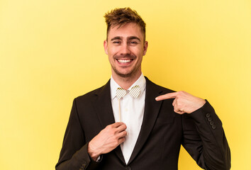 Young caucasian man celebrating new year isolated on yellow background