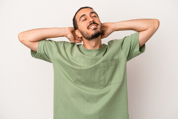 Young caucasian man isolated on white background feeling confident, with hands behind the head.