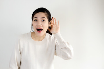 Asian beautiful women use hand cup ear  attending to listen or hear the secret news, promotion,...