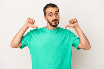 Young caucasian man isolated on white background feels proud and self confident, example to follow.