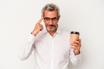 Middle age business man holding a take away coffee isolated on white background  pointing temple with finger, thinking, focused on a task.
