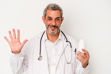 Middle age doctor caucasian man isolated on white background  smiling cheerful showing number five with fingers.