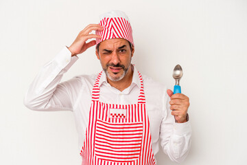 Middle age caucasian ice maker caucasian man holding a spoon isolated on white background  being shocked, she has remembered important meeting.