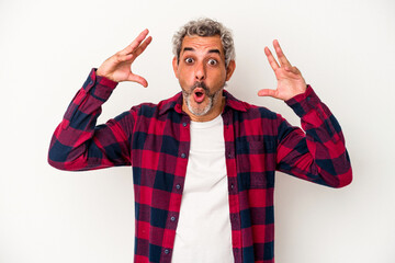 Fototapeta premium Middle age caucasian man isolated on white background celebrating a victory or success, he is surprised and shocked.
