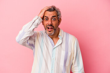 Middle age caucasian man isolated on pink background  being shocked, she has remembered important meeting.