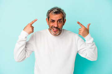 Naklejka premium Middle age caucasian man isolated on blue background showing a disappointment gesture with forefinger.