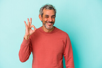 Middle age caucasian man isolated on blue background  cheerful and confident showing ok gesture.