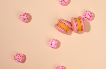 baked round macarons on a beige background, delicious dessert, top