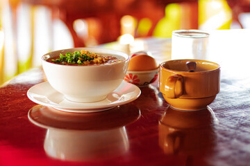 Rice porridge, coffee, boiled egg, water for breakfast before going to work