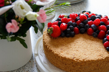 Cake decorated with fresh berries.  Honey cake.