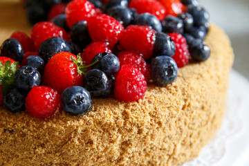 Cake decorated with fresh berries.  Honey cake.