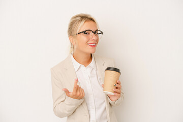 Young business Russian woman holding take away coffee isolated on white background pointing with finger at you as if inviting come closer.