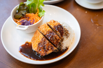 Tonkatsu Pork cutlet top on rice favorite delicious food Japanese that consists of a breaded, deep-fried pork cutlet with gravy Teriyaki sauce juicy.