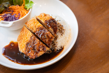 Tonkatsu Pork cutlet top on rice favorite delicious food Japanese that consists of a breaded, deep-fried pork cutlet with gravy Teriyaki sauce juicy.